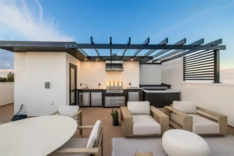 a room with stainless steel appliances kitchen island granite countertop furniture and a kitchen view