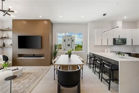a kitchen with a sink a stove and cabinets