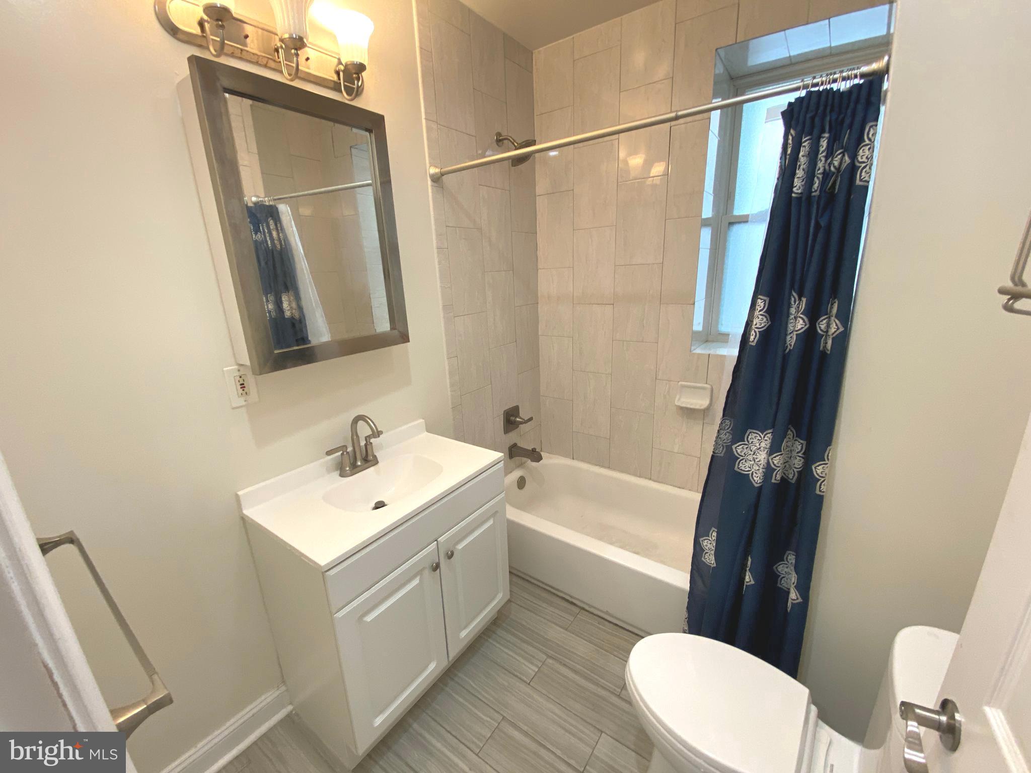 75 New York Avenue Northwest Washington, DC 20001 - Photo 11 of 32 a bathroom with a sink a toilet a mirror and shower