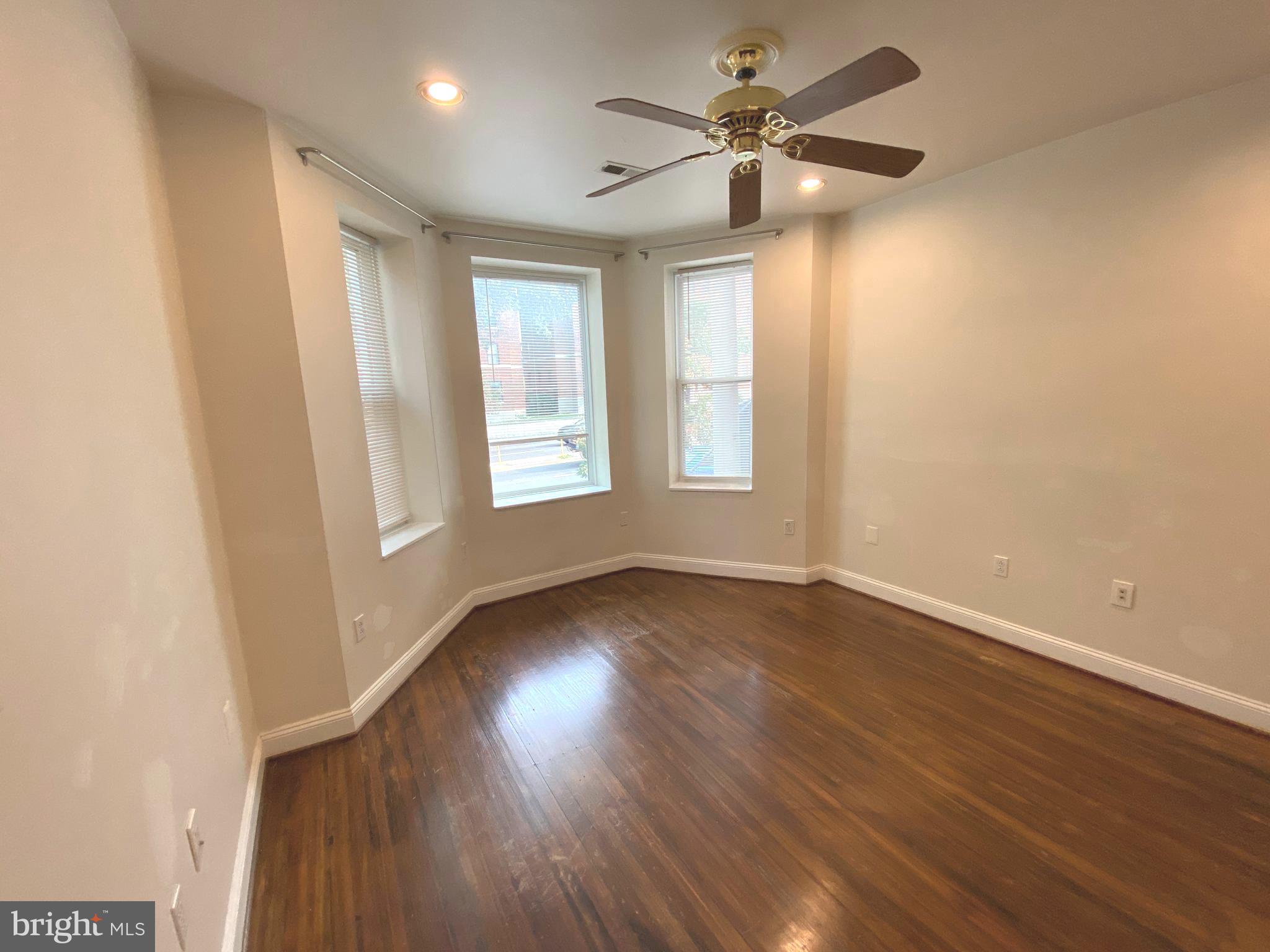 75 New York Avenue Northwest Washington, DC 20001 - Photo 12 of 32 an empty room with wooden floor and windows