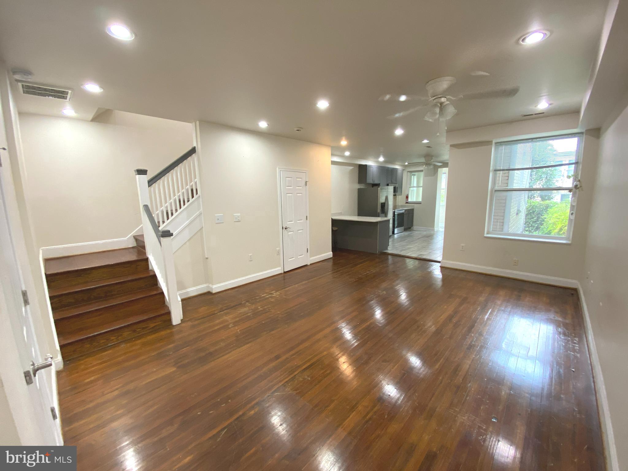 75 New York Avenue Northwest Washington, DC 20001 - Photo 16 of 32 a view of an empty room with wooden floor and a window