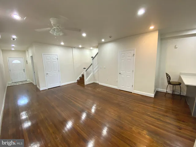 a view of a room with gym equipment and a chandelier