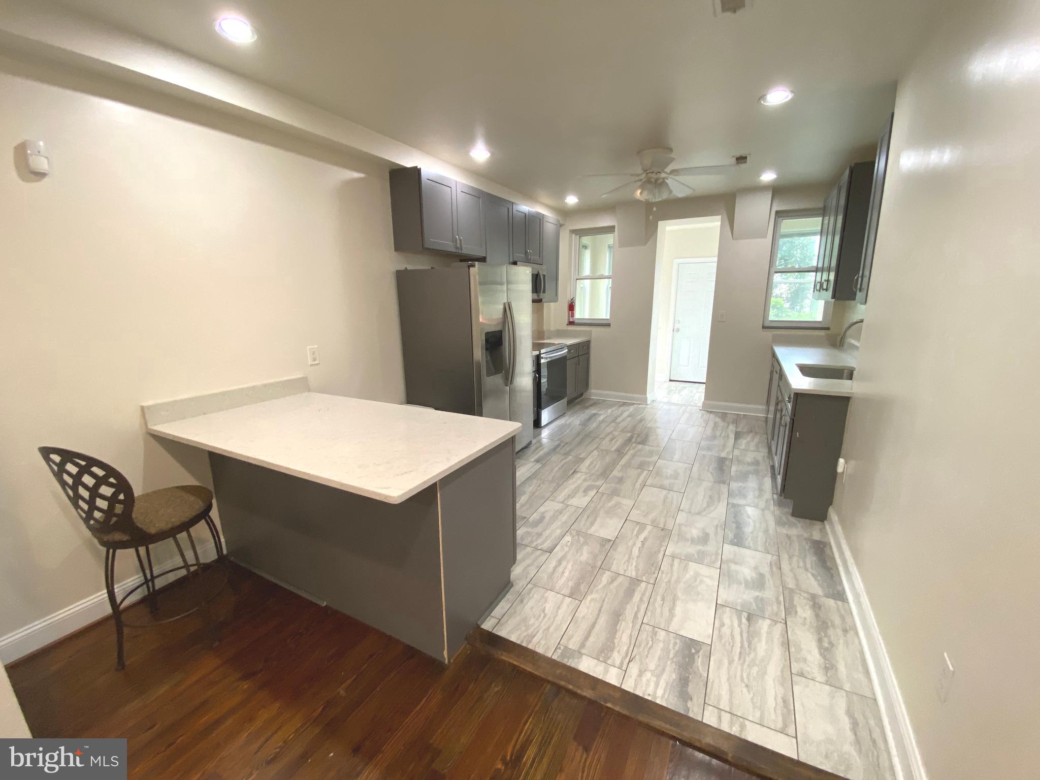75 New York Avenue Northwest Washington, DC 20001 - Photo 19 of 32 a kitchen with kitchen island white cabinets and stainless steel appliances