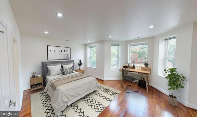 a bedroom with furniture and a potted plant