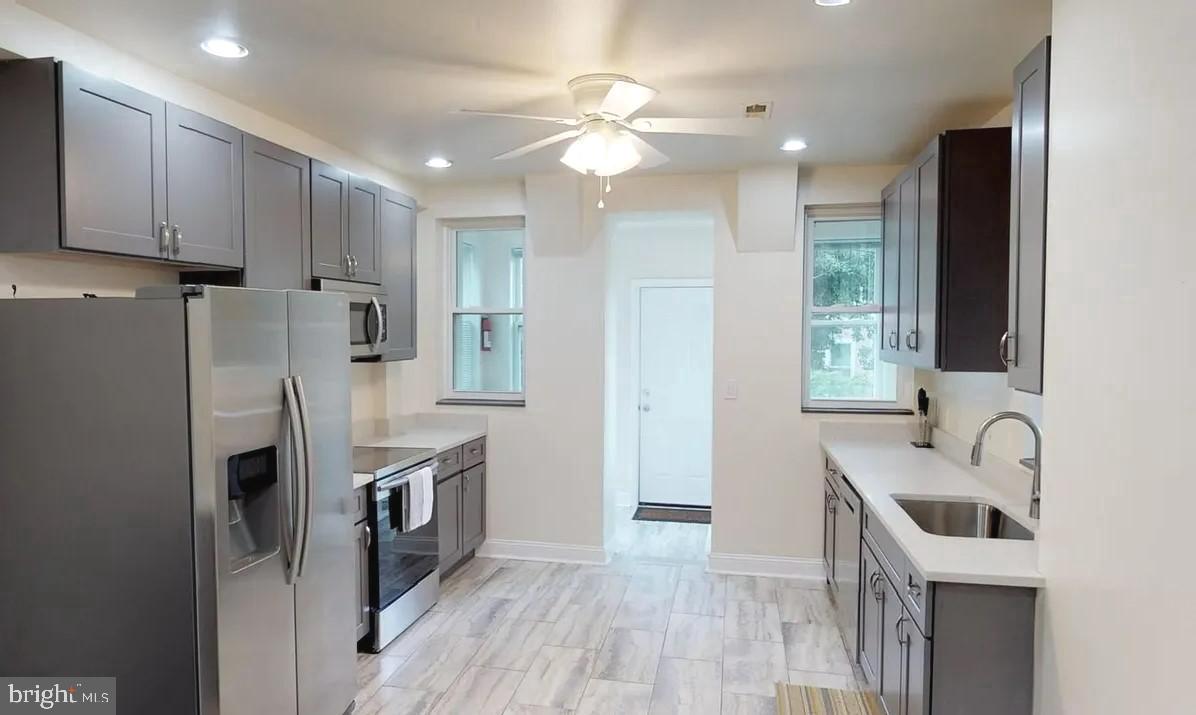75 New York Avenue Northwest Washington, DC 20001 - Photo 21 of 32 a kitchen with kitchen island granite countertop a sink stainless steel appliances and cabinets