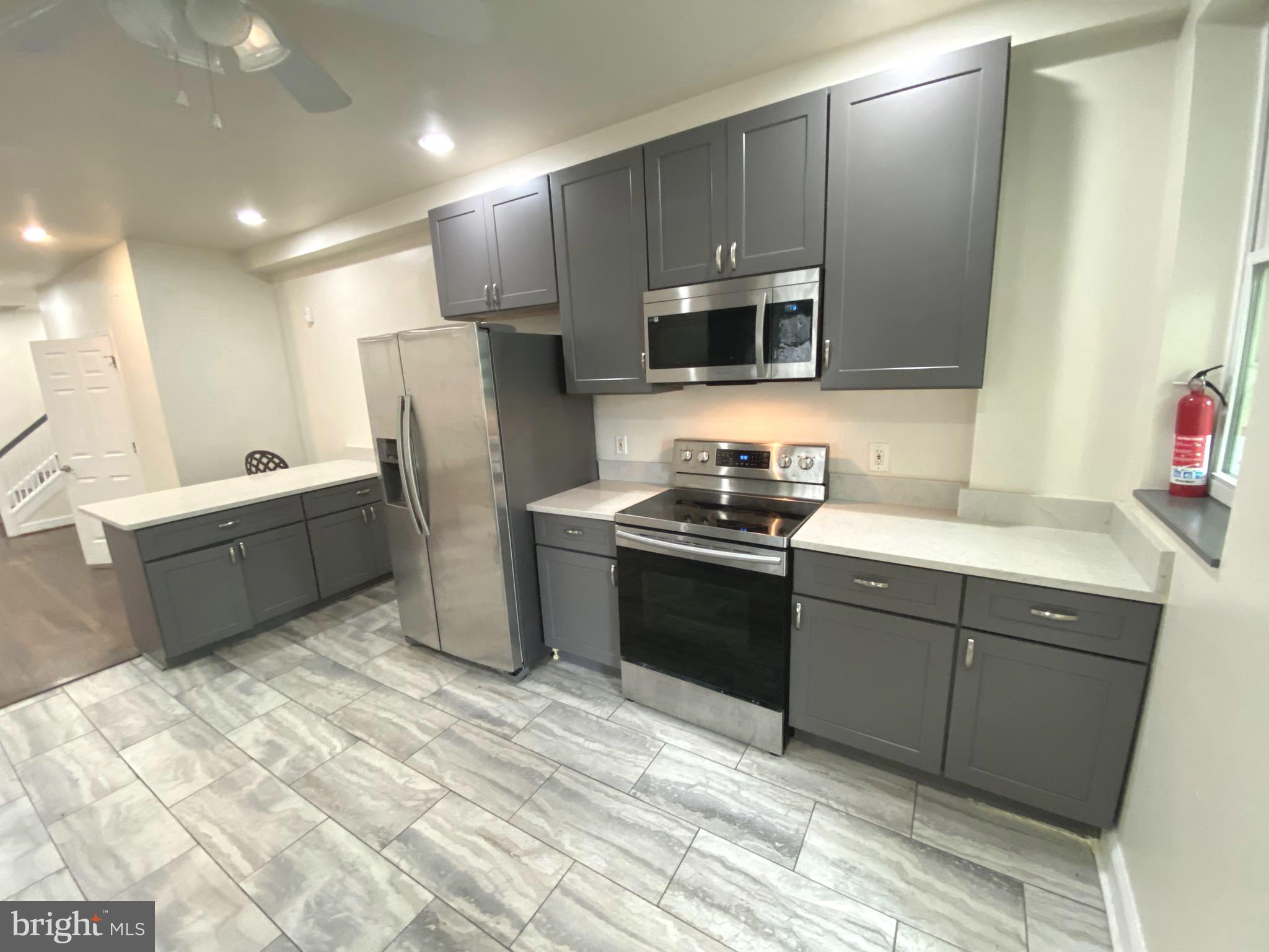 75 New York Avenue Northwest Washington, DC 20001 - Photo 23 of 32 a kitchen with stainless steel appliances kitchen island granite countertop a refrigerator and a sink