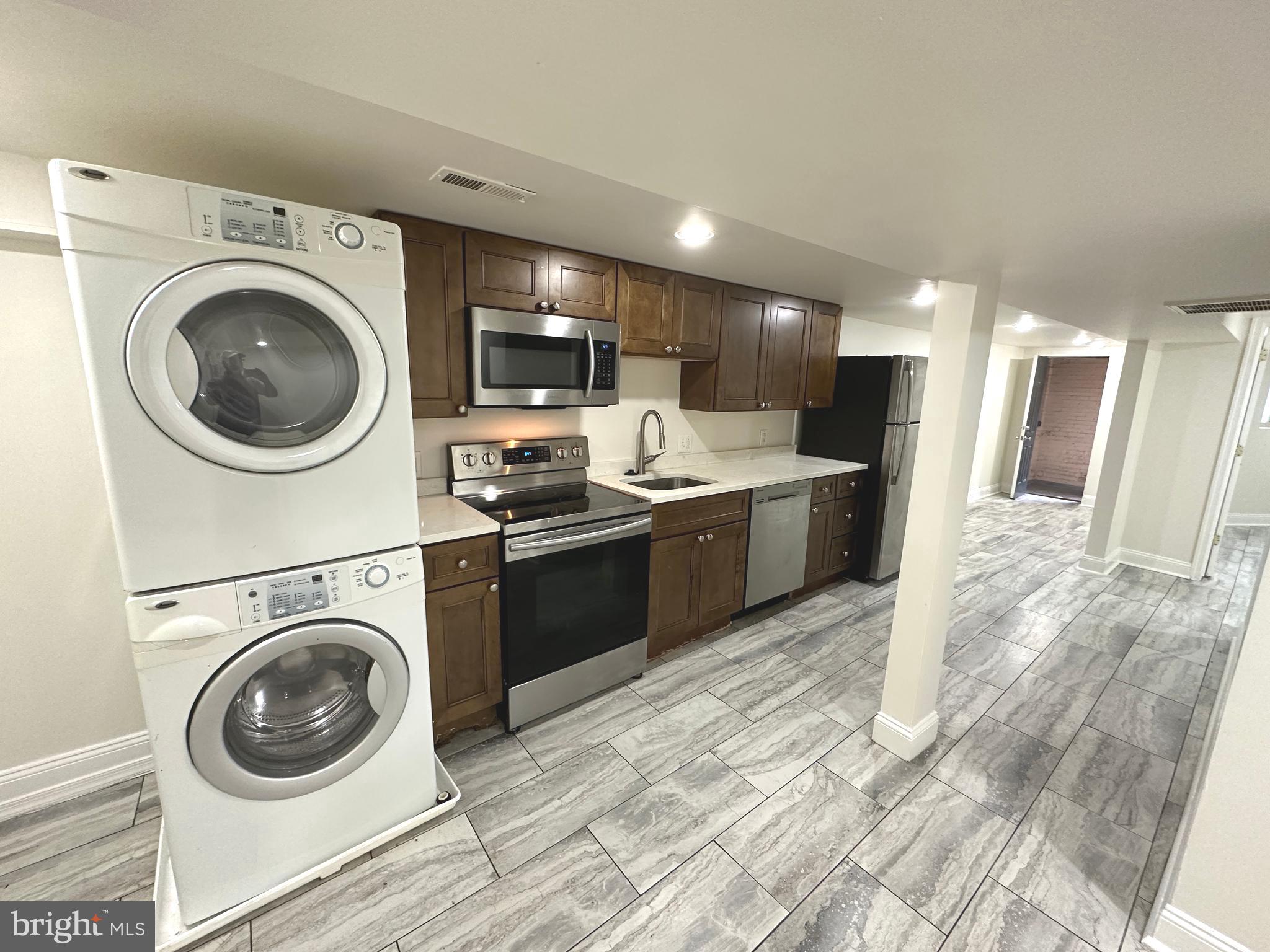 75 New York Avenue Northwest Washington, DC 20001 - Photo 25 of 32 a view of a kitchen with a stove top oven and sink