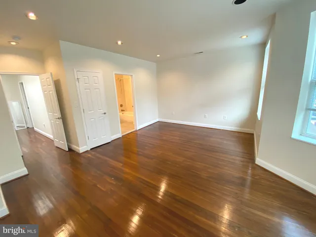 a view of hallway with wooden floor