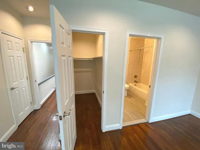 a view of hallway with wooden floor