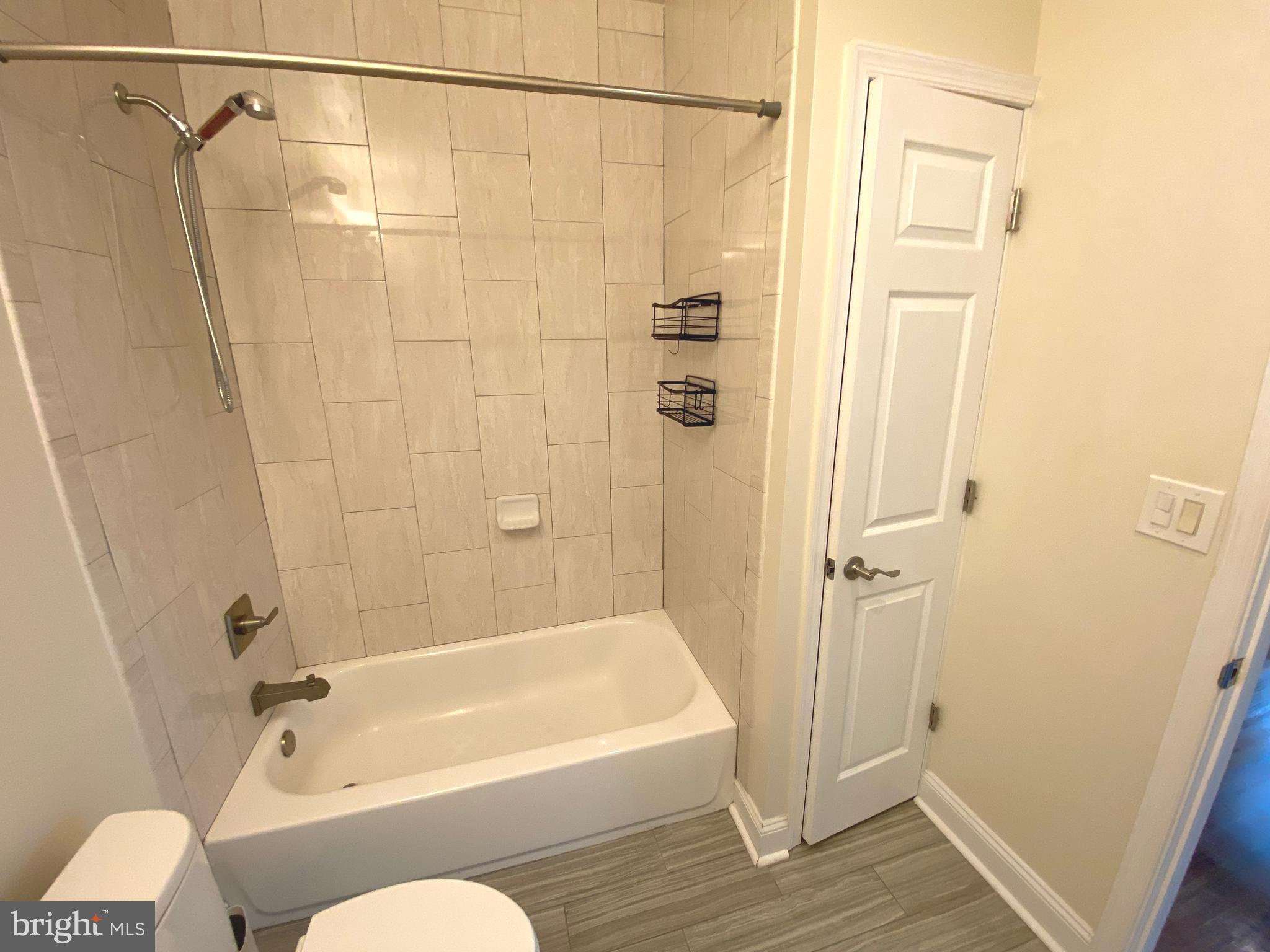 75 New York Avenue Northwest Washington, DC 20001 - Photo 7 of 32 a bathroom with a shower curtain and a bath tub