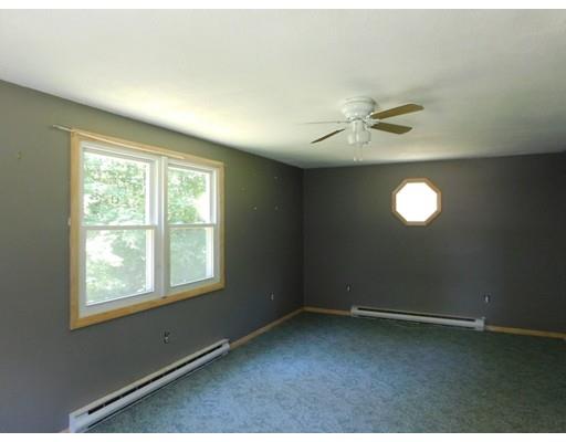 33 Bay Path Road Charlton, MA 01507 - Photo 8 of 19 an empty room with a window and a fan