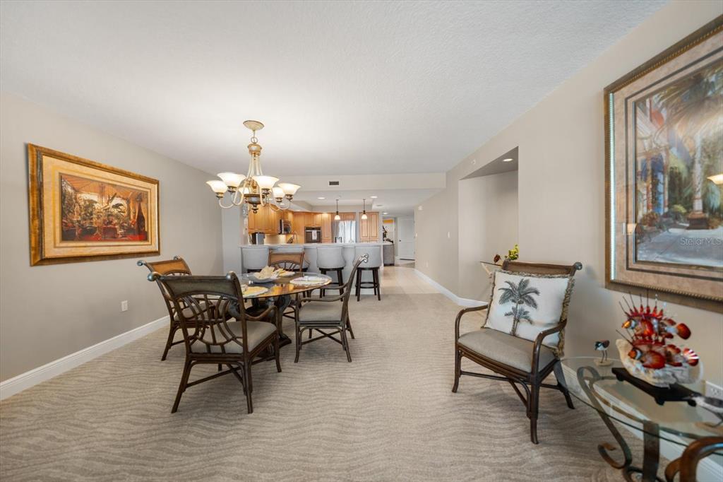 16326 Gulf Boulevard, Unit 206 Redington Beach, FL 33708 - Photo 12 of 42 a view of a dining room with furniture and chandelier