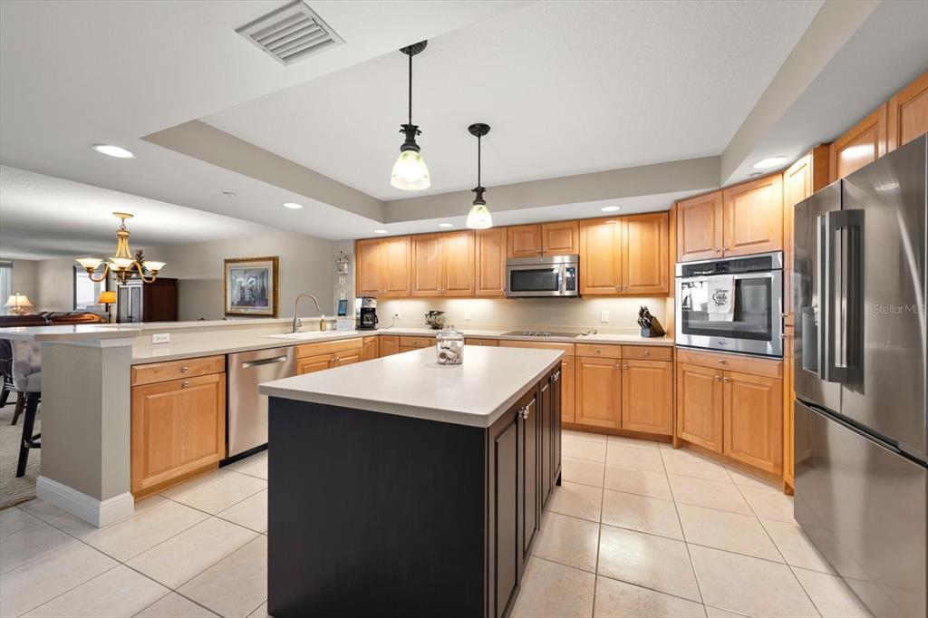 16326 Gulf Boulevard, Unit 206 Redington Beach, FL 33708 - Photo 17 of 42 a kitchen with stainless steel appliances granite countertop a sink counter space cabinets and a counter top space