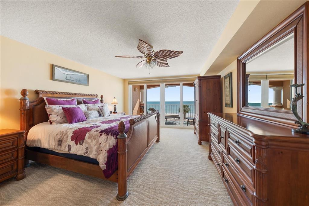 16326 Gulf Boulevard, Unit 206 Redington Beach, FL 33708 - Photo 18 of 42 a spacious bedroom with a bed and a chandelier