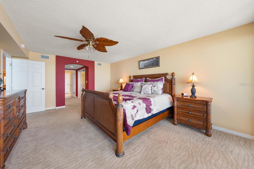 16326 Gulf Boulevard, Unit 206 Redington Beach, FL 33708 - Photo 21 of 42 a bed room with a bed and a ceiling fan