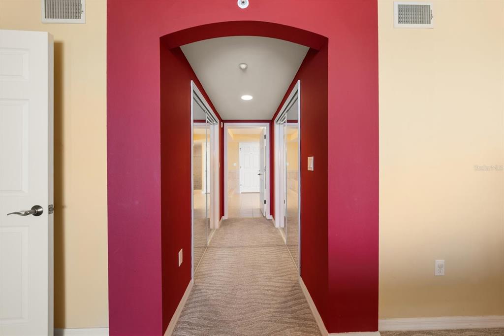 16326 Gulf Boulevard, Unit 206 Redington Beach, FL 33708 - Photo 22 of 42 a view of a hallway with wooden floor and a bathroom