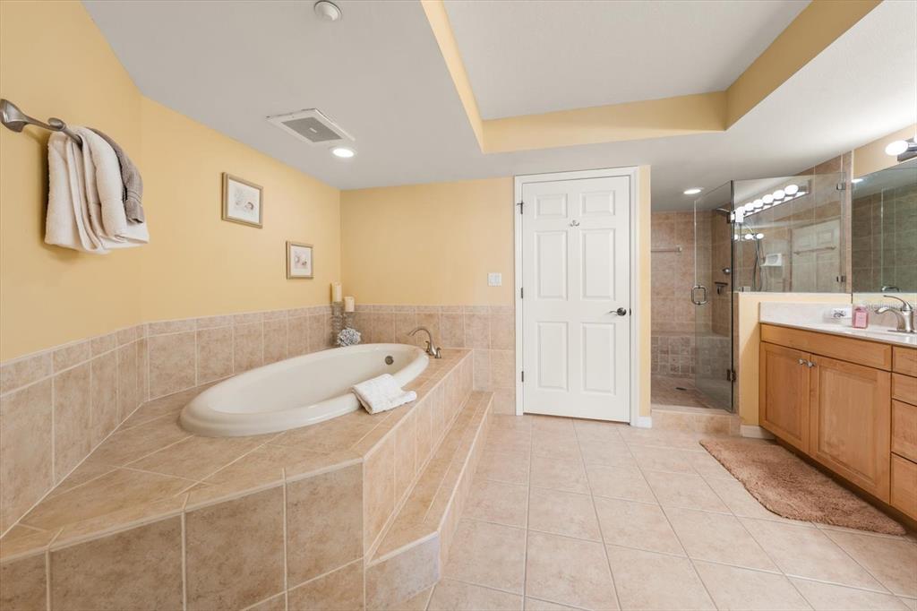 16326 Gulf Boulevard, Unit 206 Redington Beach, FL 33708 - Photo 23 of 42 a spacious bathroom with a double vanity sink a mirror and a bathtub