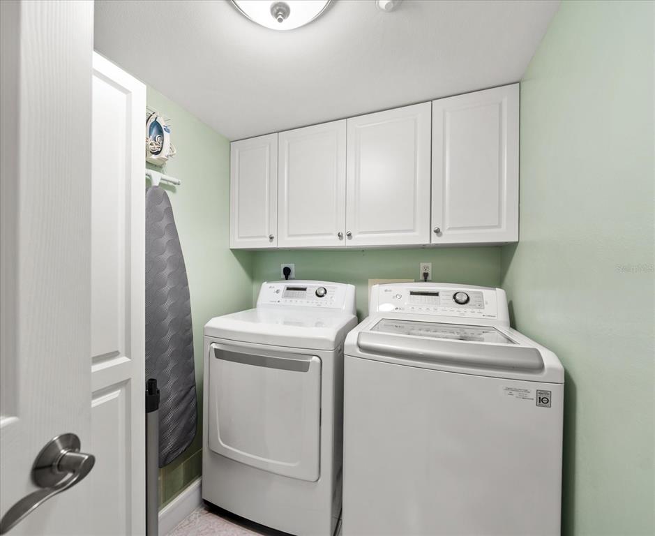 16326 Gulf Boulevard, Unit 206 Redington Beach, FL 33708 - Photo 29 of 42 a utility room with dryer and washer