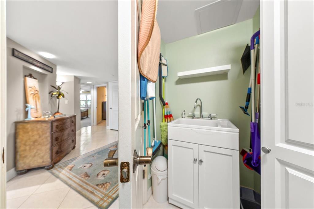 16326 Gulf Boulevard, Unit 206 Redington Beach, FL 33708 - Photo 30 of 42 a utility room with dryer and washer