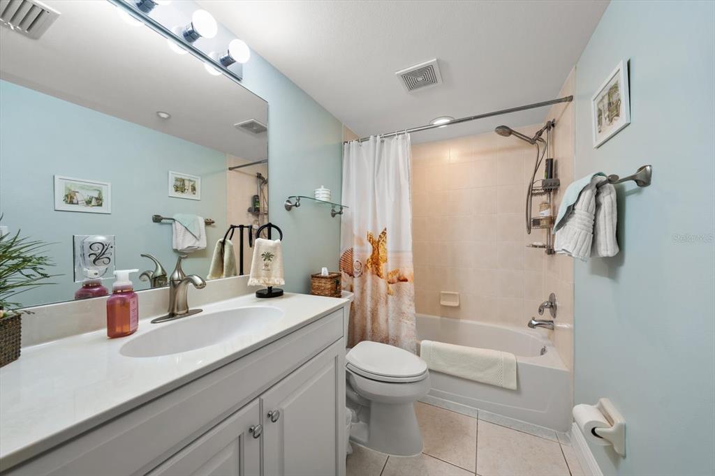 16326 Gulf Boulevard, Unit 206 Redington Beach, FL 33708 - Photo 31 of 42 a bathroom with a sink a toilet and shower