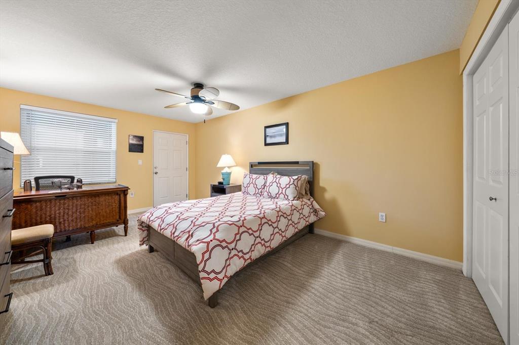 16326 Gulf Boulevard, Unit 206 Redington Beach, FL 33708 - Photo 32 of 42 a bedroom with a bed and a chandelier