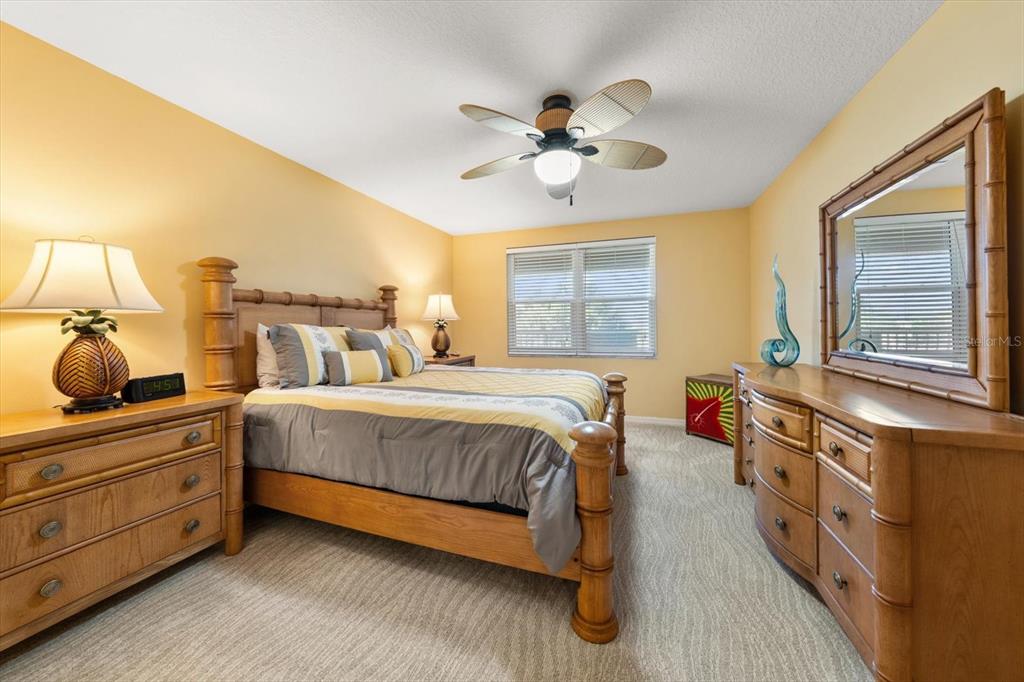 16326 Gulf Boulevard, Unit 206 Redington Beach, FL 33708 - Photo 33 of 42 a spacious bedroom with a bed and a chandelier