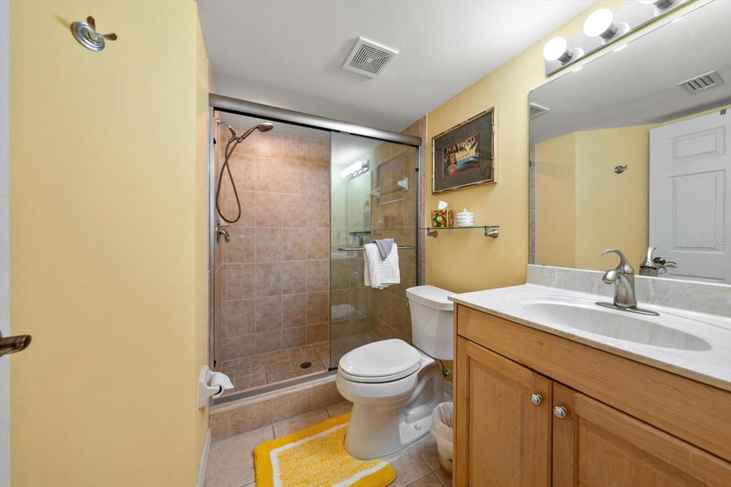 16326 Gulf Boulevard, Unit 206 Redington Beach, FL 33708 - Photo 34 of 42 a bathroom with a granite countertop sink toilet and shower