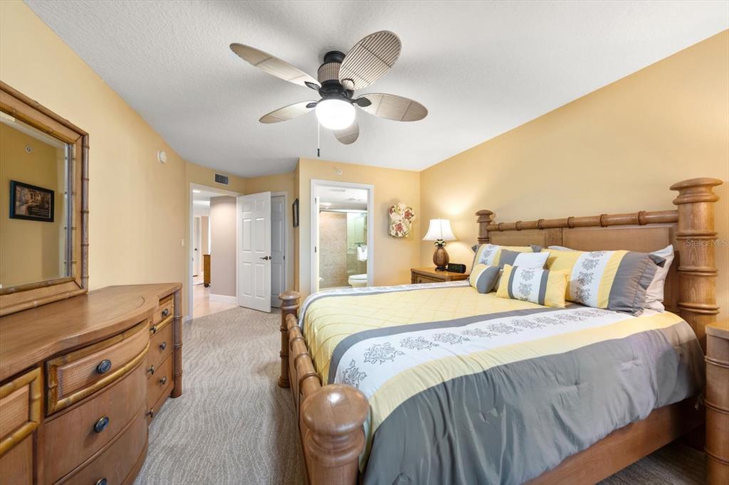 16326 Gulf Boulevard, Unit 206 Redington Beach, FL 33708 - Photo 35 of 42 a spacious bedroom with a large bed and ceiling fan