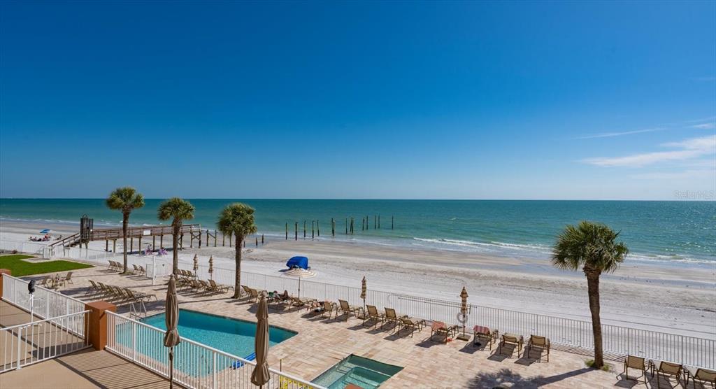 16326 Gulf Boulevard, Unit 206 Redington Beach, FL 33708 - Photo 39 of 42 a terrace with a table and chairs