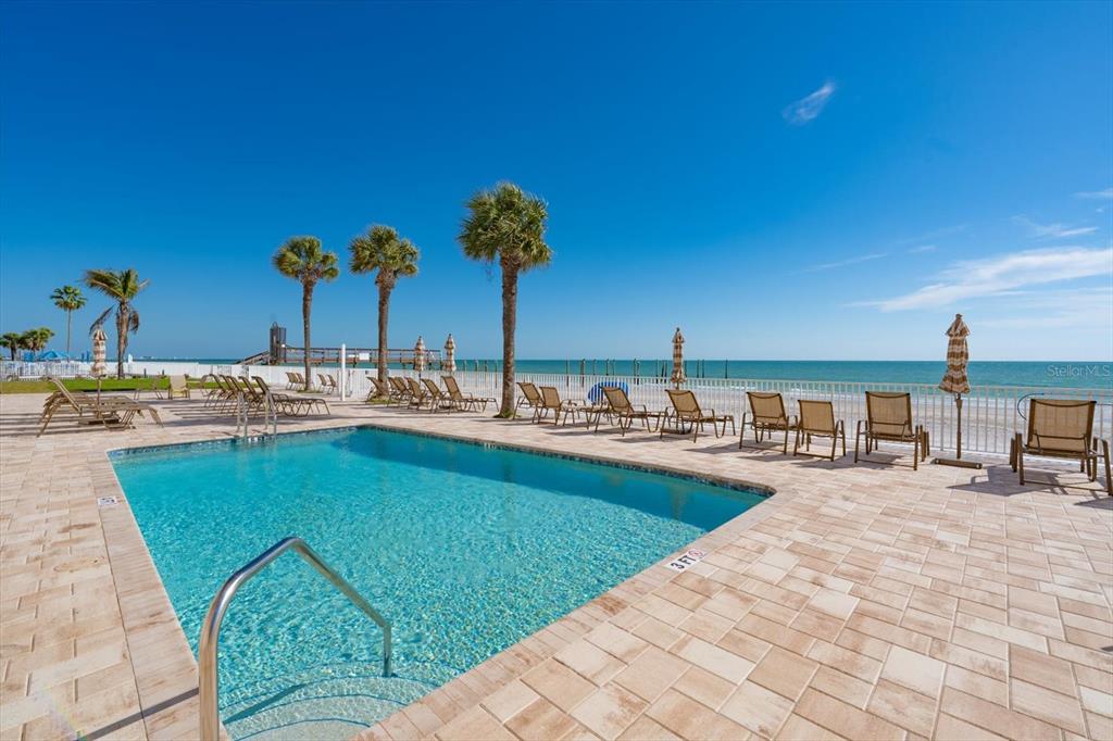 16326 Gulf Boulevard, Unit 206 Redington Beach, FL 33708 - Photo 40 of 42 a swimming pool with outdoor seating and patio