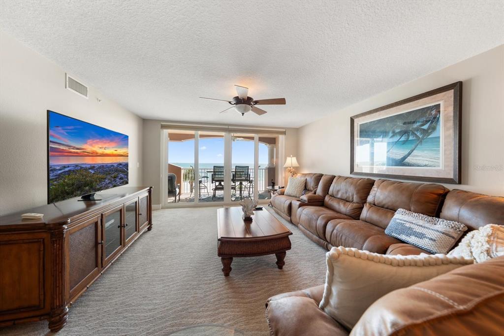 16326 Gulf Boulevard, Unit 206 Redington Beach, FL 33708 - Photo 10 of 42 a living room with furniture and a flat screen tv