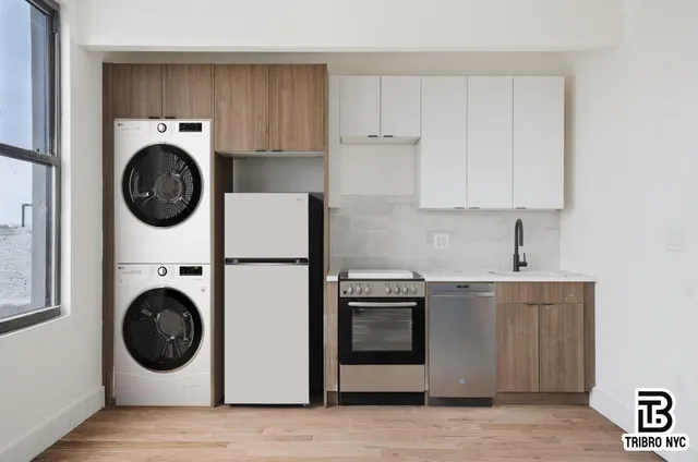 a utility room with sink dryer and washer