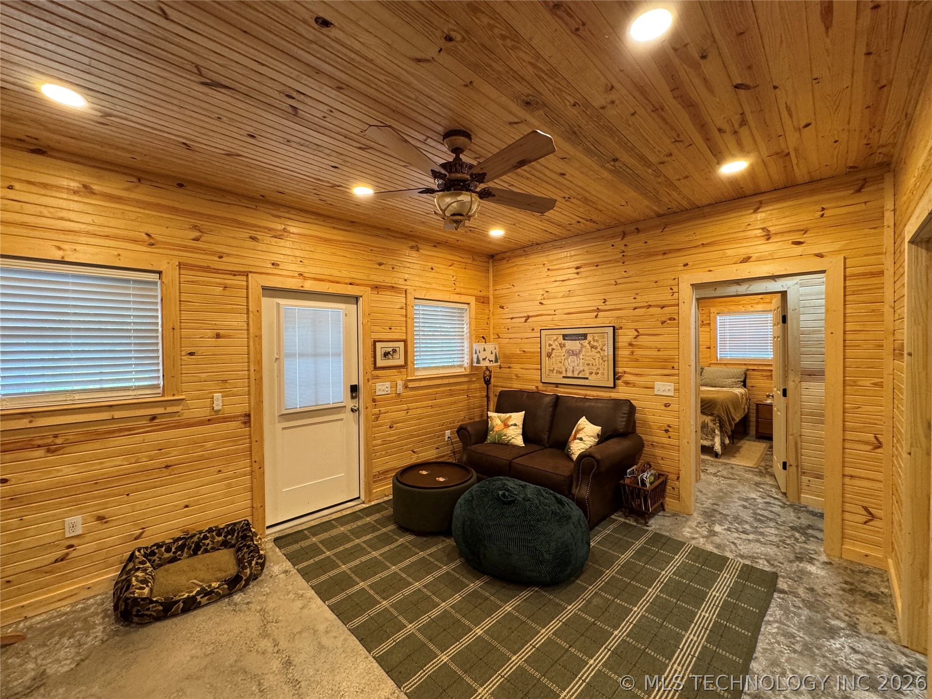 20862 East 1160th Road Keota, OK 74941 - Photo 21 of 47 Living area featuring light wood plank walls and ceiling, recessed lighting, and a ceiling fan
