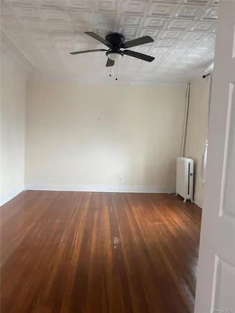 a view of an empty room and wooden floor