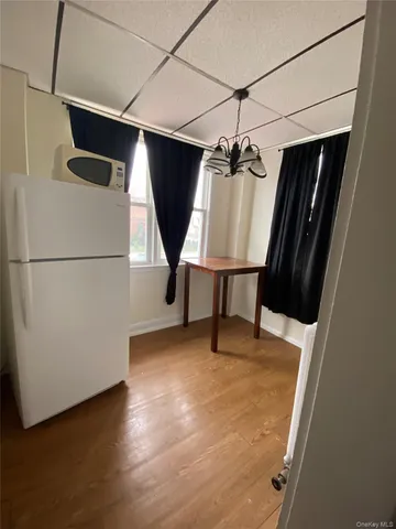 a view of storage and utility room with wooden floor