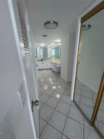 a view of entryway with kitchen and a window