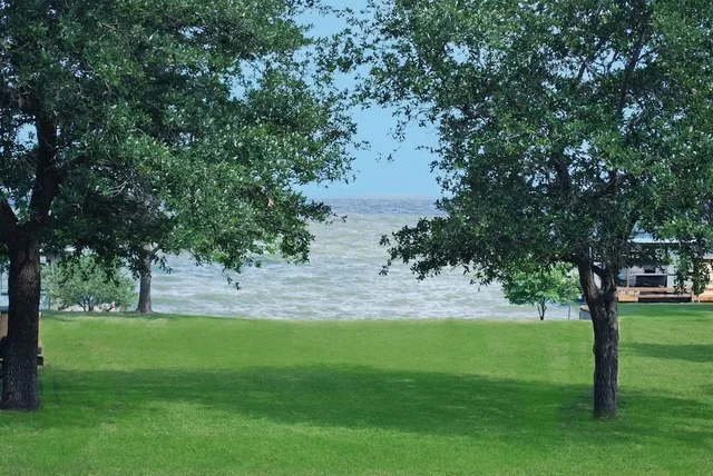 an aerial view of a house with a yard lake view