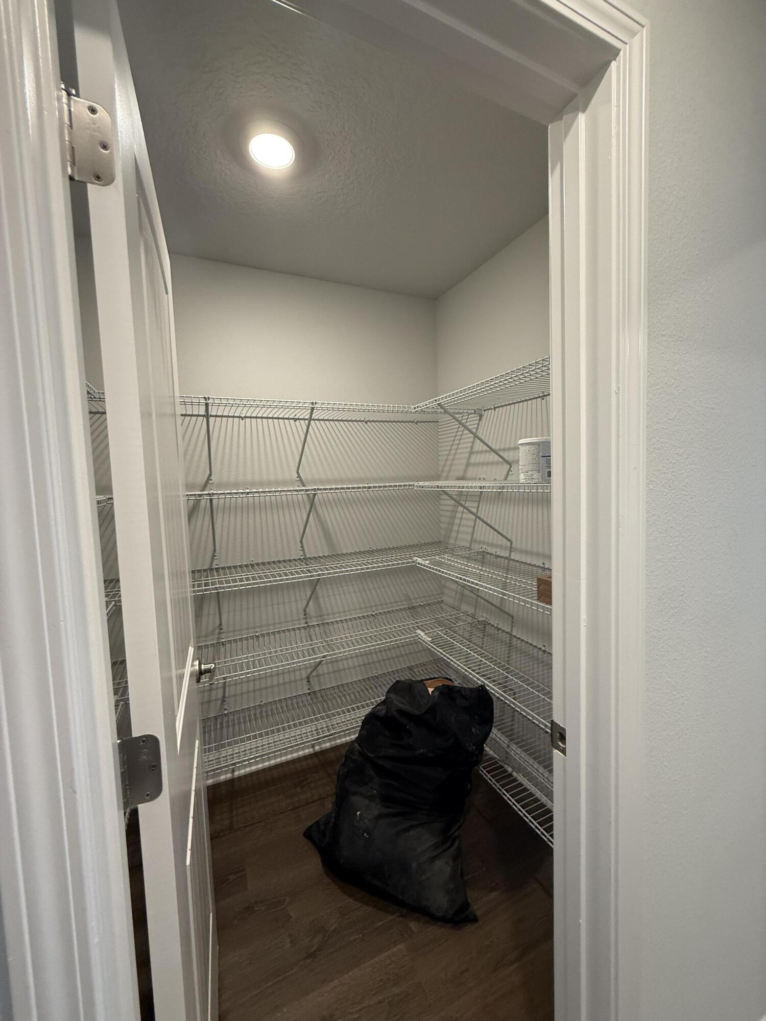 6004 Crocket Cove Crestview, FL 32539 - Photo 15 of 24 a room with a walk in closet and wooden floor