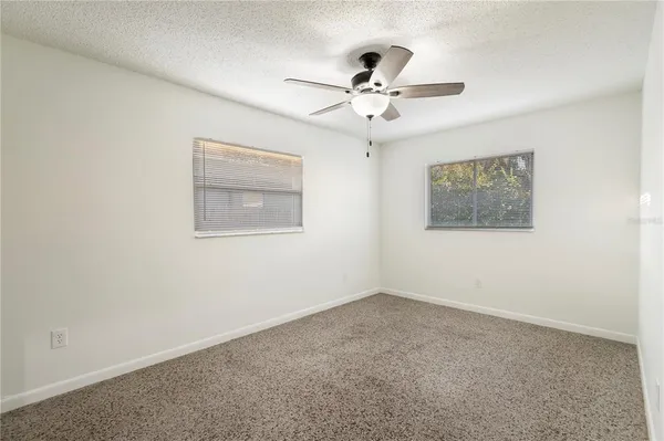 a view of an empty room with a fan