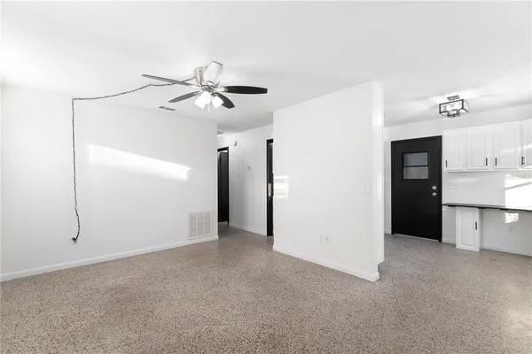 a view of a kitchen with a refrigerator and a ceiling fan