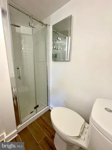 a bathroom with a toilet and a shower