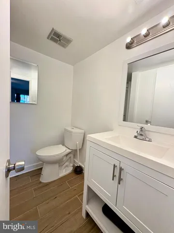 a bathroom with a sink a toilet and mirror