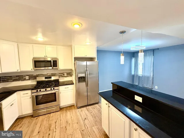 a kitchen with stainless steel appliances a sink and a microwave
