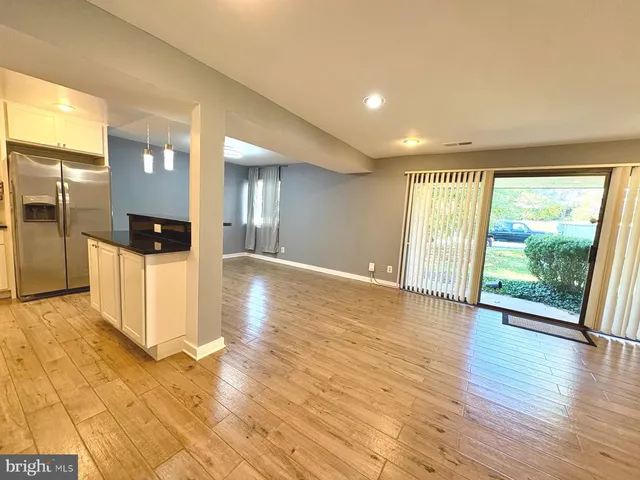 a view of a big room with windows and wooden floor