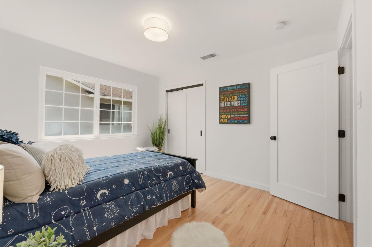 774 Ridge Rd. Santa Clara, CA 95051 - Photo 30 of 50 a bedroom with a bed window and wooden floor