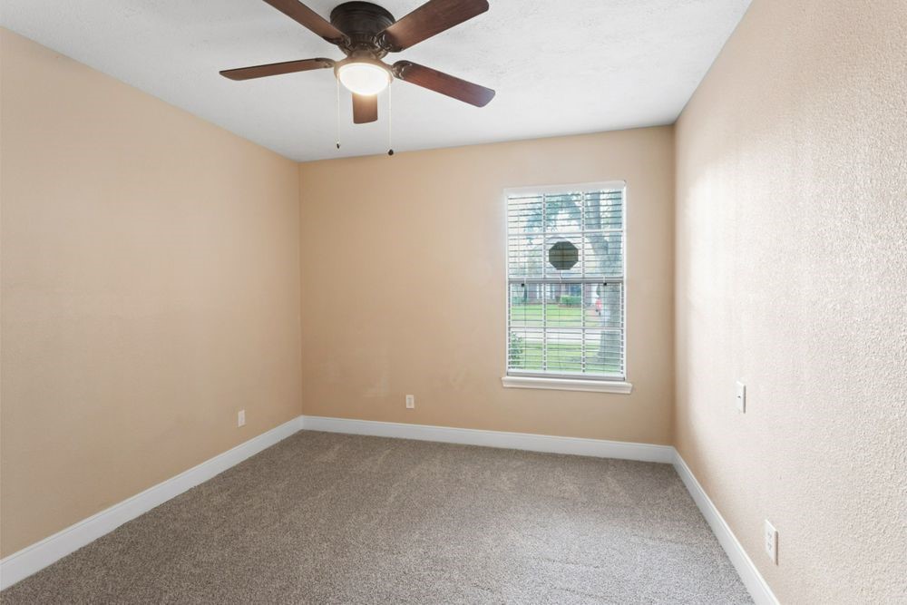 509 Teal Drive Dickinson, TX 77539 - Photo 14 of 23 an empty room with windows and fan