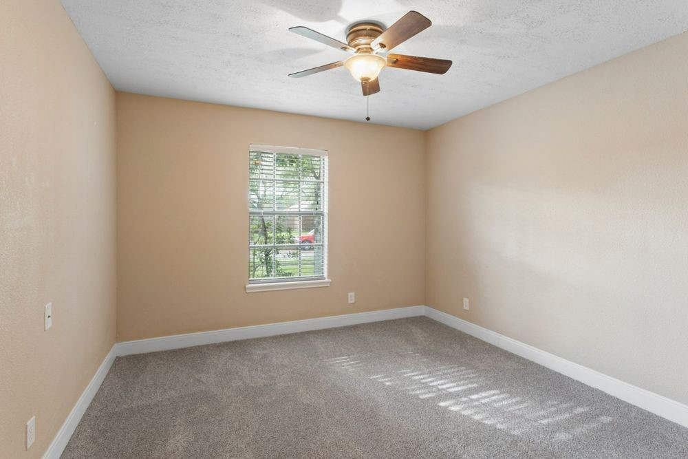 509 Teal Drive Dickinson, TX 77539 - Photo 15 of 23 an empty room with a window and a fan