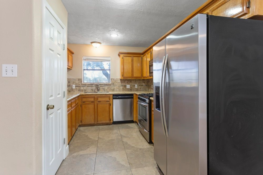 509 Teal Drive Dickinson, TX 77539 - Photo 6 of 23 a kitchen with a refrigerator sink and stove