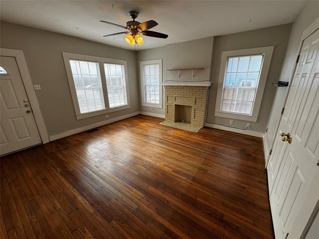 5321 Reiger Avenue, Unit 1 Dallas, TX 75214 - Photo 3 of 18 an empty room with wooden floor fireplace and windows