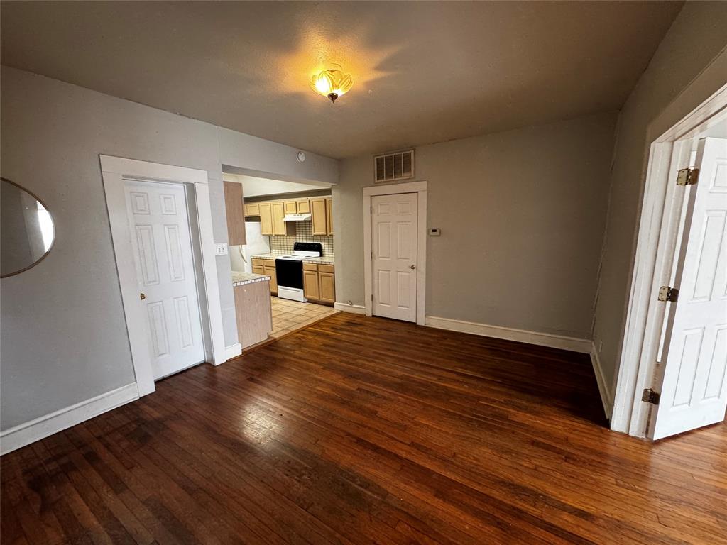 5321 Reiger Avenue, Unit 1 Dallas, TX 75214 - Photo 5 of 18 an empty room with wooden floor and windows